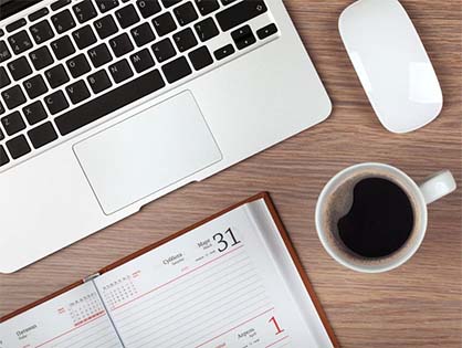 laptop, calendar and coffee mug on desk image